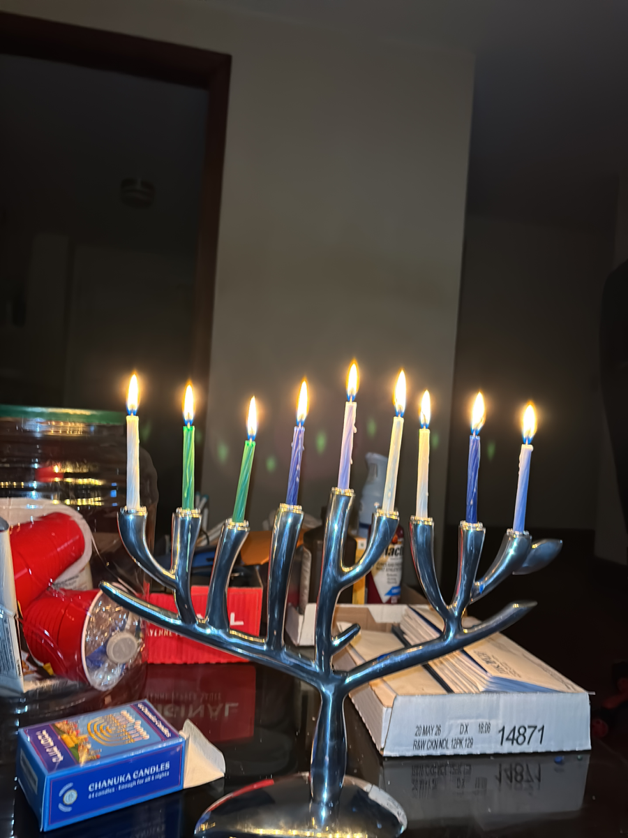 Chanukiah shaped like the Tree of Life with nine lit candles